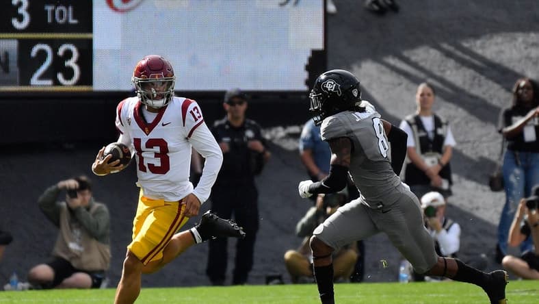Sep 30, 2023; Boulder, Colorado, USA; USC Trojans quarterback Caleb Williams (13) scrambles for a few yards as he gets chased by Colorado Buffaloes safety Jahquez Robinson (8) during the first quarter at Folsom Field. Mandatory Credit: John Leyba-USA TODAY Sports