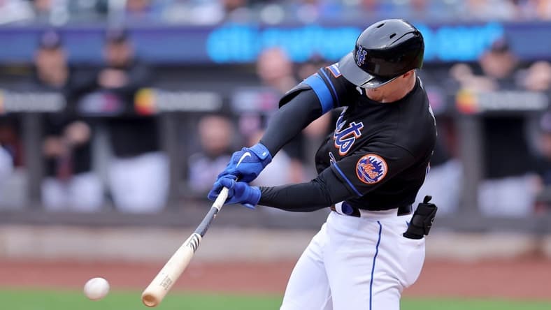 Sep 30, 2023; New York City, New York, USA; New York Mets designated hitter Brett Baty (22) hits an RBI single against the Philadelphia Phillies during the first inning at Citi Field. Mandatory Credit: Brad Penner-USA TODAY Sports