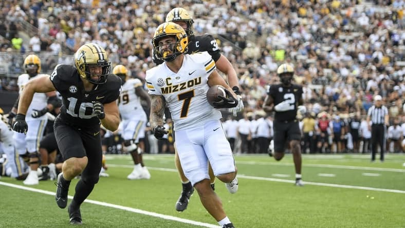 Sep 30, 2023; Nashville, Tennessee, USA; Missouri Tigers running back Cody Schrader (7) scores on a one-yard run against the Vanderbilt Commodores during the first half at FirstBank Stadium. Mandatory Credit: Steve Roberts-USA TODAY Sports