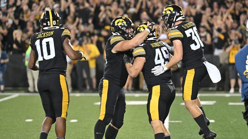 Sep 30, 2023; Iowa City, Iowa, USA; Iowa Hawkeyes defensive lineman Ethan Hurkett (49) and defensive back Quinn Schulte (30) and linebacker Nick Jackson (10) react during the fourth quarter against the Michigan State Spartans at Kinnick Stadium. Mandatory Credit: Jeffrey Becker-USA TODAY Sports