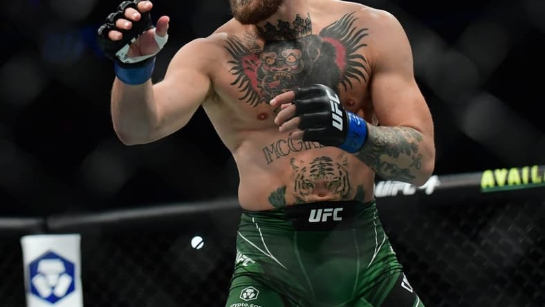 Jul 10, 2021; Las Vegas, Nevada, USA; Conor McGregor fights Dustin Poirier during UFC 264 at T-Mobile Arena. Mandatory Credit: Gary A. Vasquez-USA TODAY Sports
