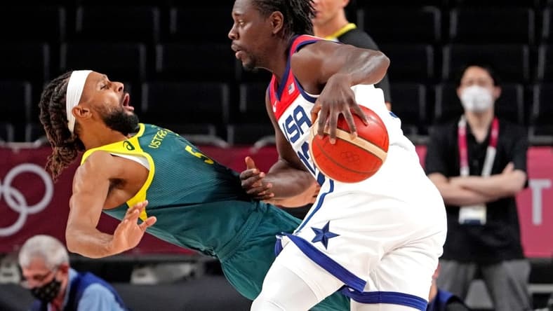 Aug 5, 2021; Saitama, Japan; United States guard Jrue Holiday (12) drives to the basket against Australia point guard Patty Mills (5) in the men's basketball semi final during the Tokyo 2020 Olympic Summer Games at Saitama Super Arena. Mandatory Credit: Kyle Terada-USA TODAY Sports