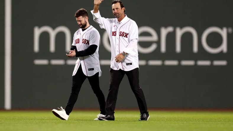 Oct 19, 2021; Boston, Massachusetts, USA; Former Boston Red Sox pitcher Tim Wakefield and singer-songwriter Calum Scott walk onto the field for a ceremonial first pitch before game four of the 2021 ALCS between the Boston Red Sox and the Houston Astros at Fenway Park. Mandatory Credit: Paul Rutherford-USA TODAY Sports