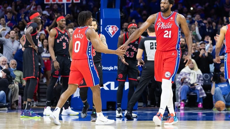 Apr 18, 2022; Philadelphia, Pennsylvania, USA; Philadelphia 76ers center Joel Embiid (21) reacts with guard Tyrese Maxey (0) after a score and one against the Toronto Raptors during the first quarter in game two of the first round for the 2022 NBA playoffs at Wells Fargo Center. Mandatory Credit: Bill Streicher-USA TODAY Sports