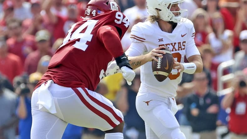 Oct 8, 2022; Dallas, Texas, USA;  Texas Longhorns quarterback Quinn Ewers (3) looks to throw as Oklahoma Sooners defensive lineman Isaiah Coe (94) chases during the game at the Cotton Bowl. Mandatory Credit: Kevin Jairaj-USA TODAY Sports