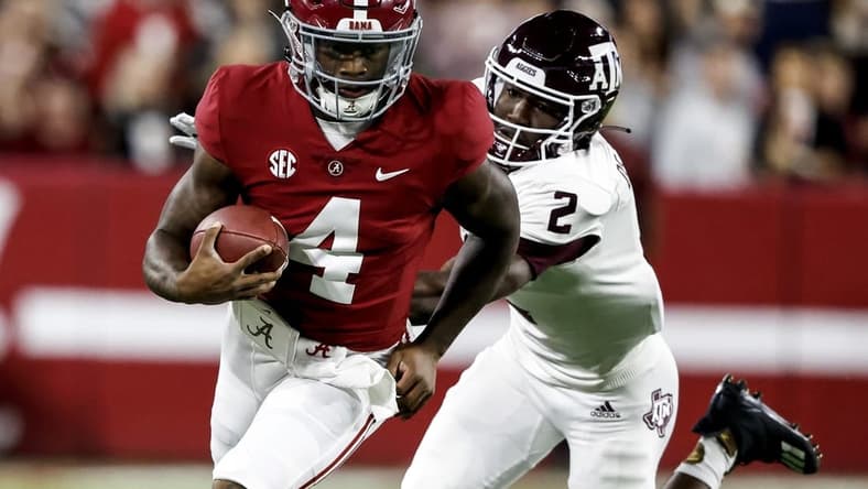 Oct 8, 2022; Tuscaloosa, Alabama, USA;  Alabama Crimson Tide quarterback Jalen Milroe (4) scrambles for yardage against Texas A&M Aggies defensive back Denver Harris (2) during the first half at Bryant-Denny Stadium. Mandatory Credit: Butch Dill-USA TODAY Sports
