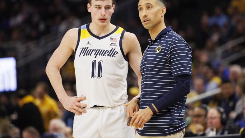 Dec 16, 2022; Milwaukee, Wisconsin, USA;  Marquette Golden Eagles head coach Shaka Smart talks with guard Tyler Kolek (11) during the game against the Creighton Bluejays at Fiserv Forum. Mandatory Credit: Jeff Hanisch-USA TODAY Sports