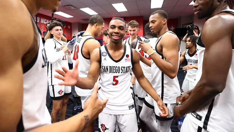 Apr 1, 2023; Houston, TX, USA; San Diego State Aztecs guard Lamont Butler (5) celebrates in the locker room with teammates in the semifinals of the Final Four in the 2023 NCAA Tournament against the Florida Atlantic Owls at NRG Stadium. Mandatory Credit: Jamie Schwaberow/Pool Photo-USA TODAY Sports