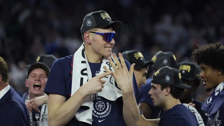 Apr 3, 2023; Houston, TX, USA; Connecticut Huskies center Donovan Clingan (32) celebrates after defeating the San Diego State Aztecs in the national championship game of the 2023 NCAA Tournament at NRG Stadium. Mandatory Credit: Bob Donnan-USA TODAY Sports
