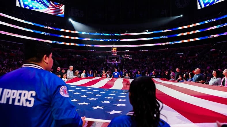 Apr 8, 2023; Los Angeles, California, USA; LA Clippers fans hold the American flag during a pre-game ceremony against the Portland Trail Blazers at Crypto.com Arena. Mandatory Credit: Jonathan Hui-USA TODAY Sports