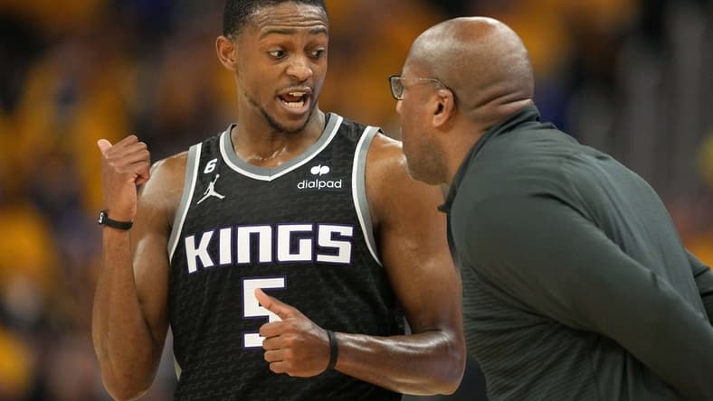 Apr 23, 2023; San Francisco, California, USA; Sacramento Kings guard De'Aaron Fox (5) talks to head coach Mike Brown during the second quarter of game four of the 2023 NBA playoffs against the Golden State Warriors at Chase Center. Mandatory Credit: Darren Yamashita-USA TODAY Sports