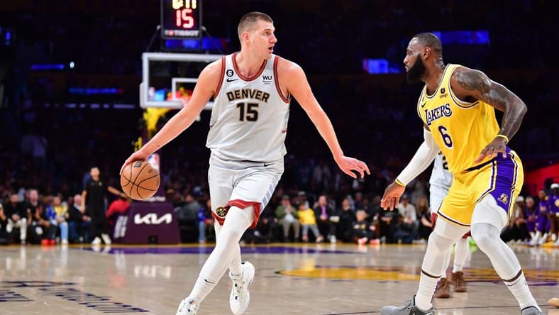 May 22, 2023; Los Angeles, California, USA; Denver Nuggets center Nikola Jokic (15) drives to the basket against Los Angeles Lakers forward LeBron James (6) during the second quarter in game four of the Western Conference Finals for the 2023 NBA playoffs at Crypto.com Arena. Mandatory Credit: Gary A. Vasquez-USA TODAY Sports