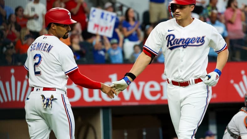 Sep 4, 2023; Arlington, Texas, USA; Texas Rangers shortstop Corey Seager (5) celebrates with Texas Rangers second baseman Marcus Semien (2) after hitting a two run home run during the first inning against the Houston Astros at Globe Life Field. Mandatory Credit: Kevin Jairaj-USA TODAY Sports