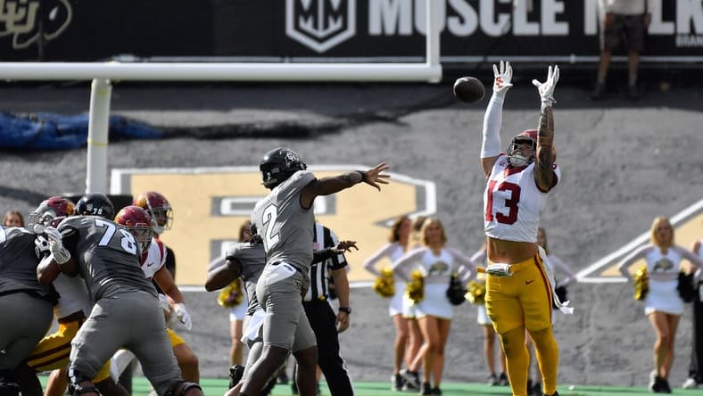 Sep 30, 2023; Boulder, Colorado, USA; Colorado Buffaloes quarterback Shedeur Sanders (2) gets his pass knocked down by USC Trojans linebacker Mason Cobb (13) during the first quarter at Folsom Field. Mandatory Credit: John Leyba-USA TODAY Sports