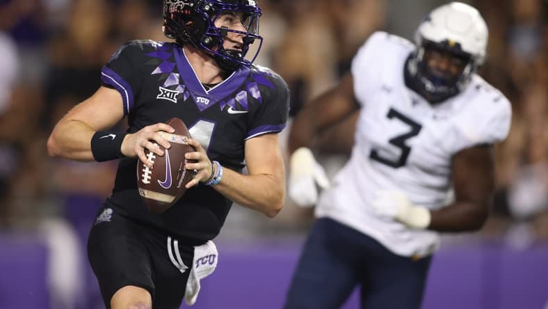 Sep 30, 2023; Fort Worth, Texas, USA; TCU Horned Frogs quarterback Chandler Morris (4) rolls out to pass against West Virginia Mountaineers defensive lineman Tomiwa Durojaiye (3) in the second quarter at Amon G. Carter Stadium. Mandatory Credit: Tim Heitman-USA TODAY Sports