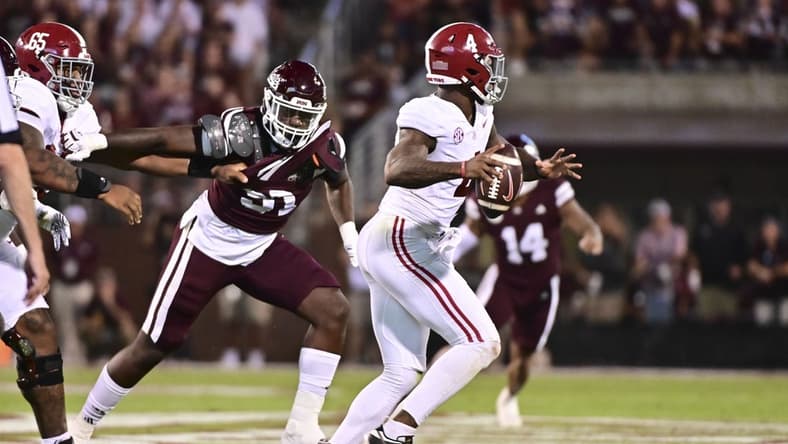 Sep 30, 2023; Starkville, Mississippi, USA; Alabama Crimson Tide quarterback Jalen Milroe (4) moves in the pocket while defended by Mississippi State Bulldogs defensive end Deonte Anderson (91) during the second quarter at Davis Wade Stadium at Scott Field. Mandatory Credit: Matt Bush-USA TODAY Sports