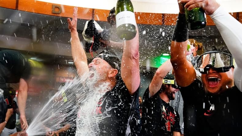 Sep 30, 2023; Phoenix, AZ, USA; Arizona Diamondbacks manager Torey Lovullo is sprayed with champagne during celebrations after clinching a wild card playoff spot following their game with the Houston Astros at Chase Field. Mandatory Credit: Rob Schumacher-Arizona Republic