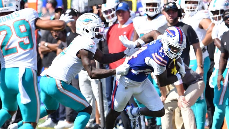 Oct 1, 2023; Orchard Park, New York, USA; Buffalo Bills wide receiver Stefon Diggs (14) breaks a tackle by Miami Dolphins cornerback Kader Kohou (4) to score a touchdown in the second quarter at Highmark Stadium. Mandatory Credit: Mark Konezny-USA TODAY Sports