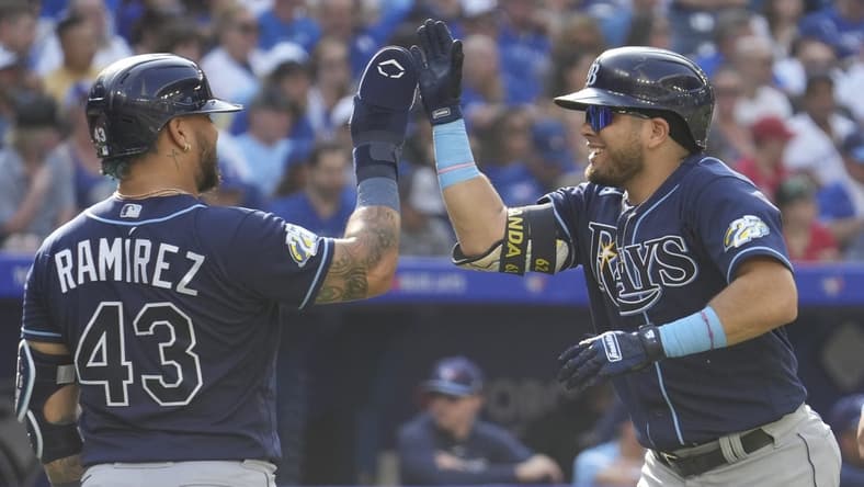Oct 1, 2023; Toronto, Ontario, CAN; Tampa Bay Rays designated hitter Harold Ramirez (43) congratulates first baseman Jonathan Aranda (62) after his grandslam home run against the Toronto Blue Jays during the second inning at Rogers Centre. Mandatory Credit: John E. Sokolowski-USA TODAY Sports