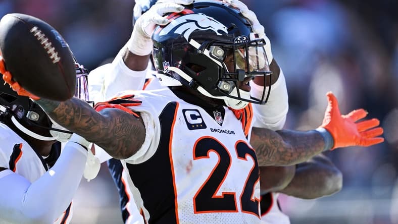 Oct 1, 2023; Chicago, Illinois, USA;  Denver Broncos safety Kareem Jackson (22) celebrates after intercepting a Chicago Bears pass in the fourth quarter at Soldier Field. Mandatory Credit: Jamie Sabau-USA TODAY Sports