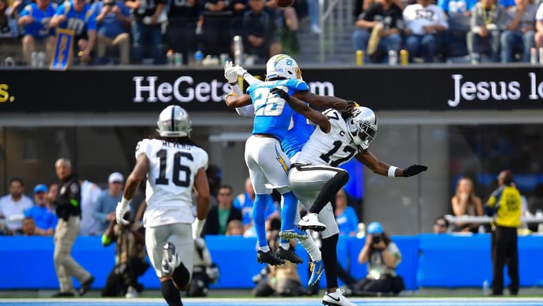 Oct 1, 2023; Inglewood, California, USA; Los Angeles Chargers cornerback Asante Samuel Jr. (26) blocks a pass intended for Las Vegas Raiders wide receiver Davante Adams (17) during the second half at SoFi Stadium. Mandatory Credit: Gary A. Vasquez-USA TODAY Sports