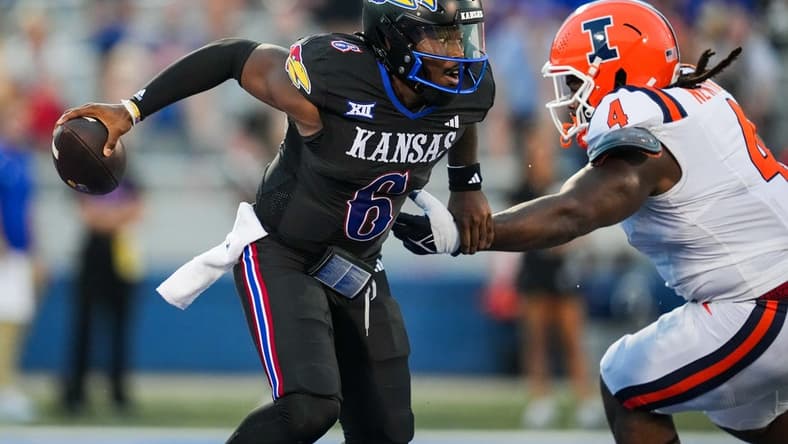Sep 8, 2023; Lawrence, Kansas, USA; Kansas Jayhawks quarterback Jalon Daniels (6) against Illinois Fighting Illini defensive lineman Jer'Zhan Newton (4) during the first half at David Booth Kansas Memorial Stadium. Mandatory Credit: Jay Biggerstaff-USA TODAY Sports