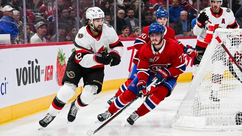 Sep 27, 2023; Montreal, Quebec, CAN; Montreal Canadiens center Kirby Dach (77) defends the puck against Ottawa Senators left wing Jiri Smejkal (13) during the second period at Bell Centre. Mandatory Credit: David Kirouac-USA TODAY Sports
