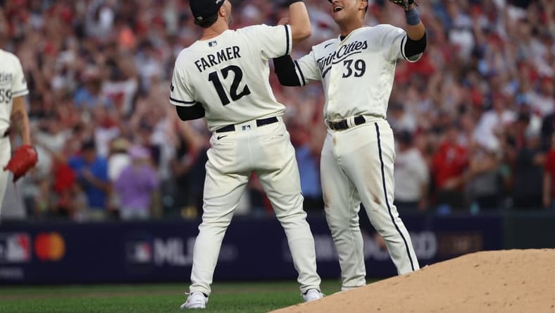 Oct 3, 2023; Minneapolis, Minnesota, USA; Minnesota Twins third baseman Kyle Farmer (12) and first baseman Donovan Solano (39) celebrated after defeating Toronto Blue Jays  during game one of the Wildcard series for the 2023 MLB playoffs at Target Field. Mandatory Credit: Jesse Johnson-USA TODAY Sports