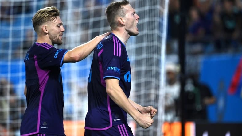 Oct 4, 2023; Charlotte, North Carolina, USA; Charlotte FC forward Karol widerski (11) celebrates with midfielder Kamil J wiak (7) after scoring his second goal in the first half at Bank of America Stadium. Mandatory Credit: Bob Donnan-USA TODAY Sports