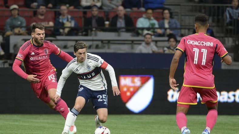 Oct 4, 2023; Vancouver, British Columbia, CAN; Vancouver Whitecaps FC midfielder Ryan Gauld (25) controls the ball against St. Louis City SC midfielder Eduard Lowen (10) during the first half at BC Place. Mandatory Credit: Anne-Marie Sorvin-USA TODAY Sports