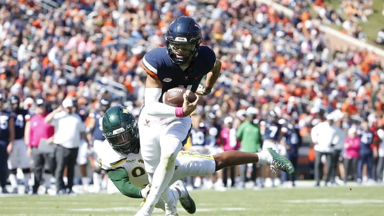 Oct 7, 2023; Charlottesville, Virginia, USA; Virginia Cavaliers quarterback Tony Muskett (11) scores a touchdown past William & Mary Tribe defensive lineman Nate Lynn (99) during the first half at Scott Stadium. Mandatory Credit: Amber Searls-USA TODAY Sports