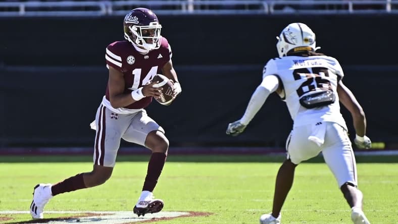 Oct 7, 2023; Starkville, Mississippi, USA; Mississippi State Bulldogs quarterback Mike Wright (14) runs the ball while defended by Western Michigan Broncos cornerback Aaron Wofford (25) during the fourth quarter at Davis Wade Stadium at Scott Field. Mandatory Credit: Matt Bush-USA TODAY Sports