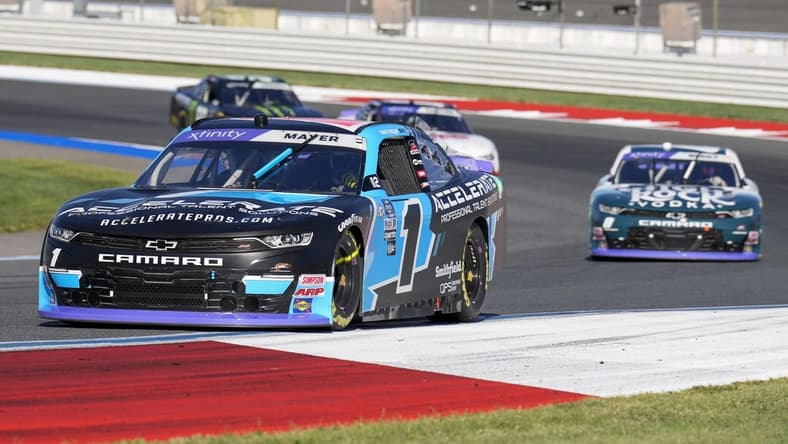 Oct 7, 2023; Concord, North Carolina, USA; NASCAR Xfinity Series driver Sam Mayer (1) leads driver Josh Berry (8) out of turn five during the Drive for the Cure 250 at Charlotte Motor Speedway Road Course. Mandatory Credit: Jim Dedmon-USA TODAY Sports