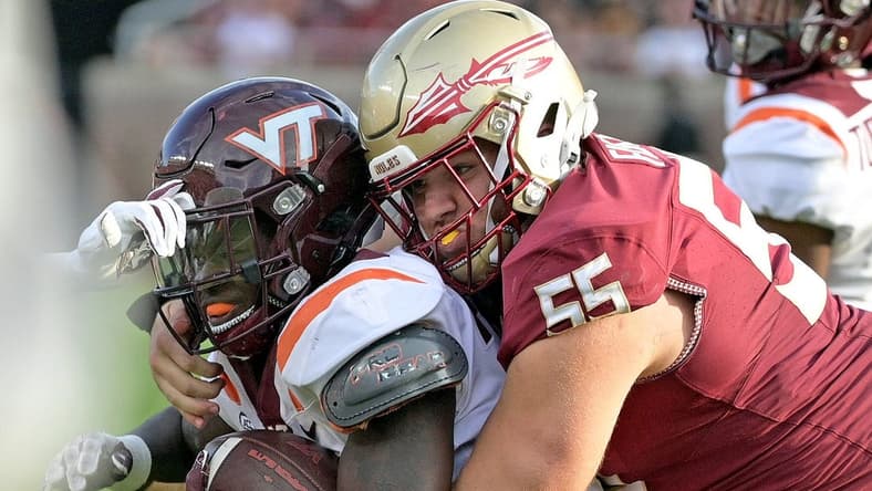 Oct 7, 2023; Tallahassee, Florida, USA; Virginia Tech Hokies running back Malachi Thomas (24) is tackled by Florida State Seminoles defensive lineman Braden Fiske (55) during the second half at Doak S. Campbell Stadium. Mandatory Credit: Melina Myers-USA TODAY Sports