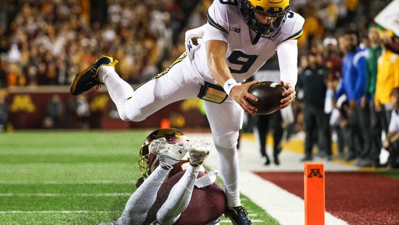 Oct 7, 2023; Minneapolis, Minnesota, USA; Michigan Wolverines quarterback J.J. McCarthy (9) dives for a  touchdown against the Minnesota Golden Gophers during the second quarter at Huntington Bank Stadium. Mandatory Credit: Matt Krohn-USA TODAY Sports