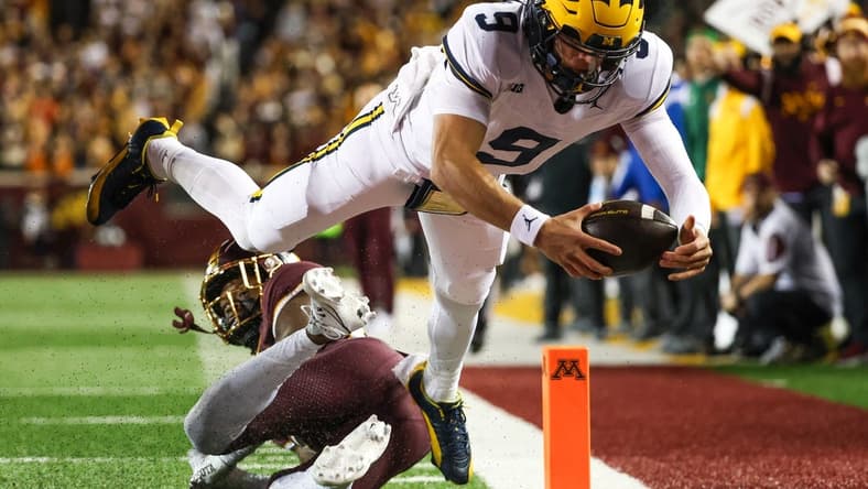 Oct 7, 2023; Minneapolis, Minnesota, USA; Michigan Wolverines quarterback J.J. McCarthy (9) dives for a  touchdown against the Minnesota Golden Gophers during the second quarter at Huntington Bank Stadium. Mandatory Credit: Matt Krohn-USA TODAY Sports