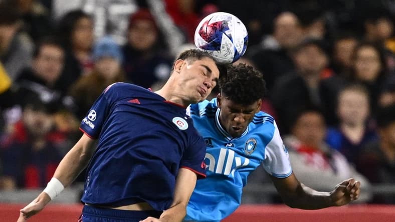 Oct 7, 2023; Chicago, Illinois, USA;  Chicago Fire FC forward Georgios Koutsias (19) and Charlotte FC defender Adilson Malanda (29) battle for control of the ball in the first half at Soldier Field. Mandatory Credit: Jamie Sabau-USA TODAY Sports
