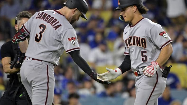 Oct 7, 2023; Los Angeles, California, USA; Arizona Diamondbacks center fielder Alek Thomas (5) reacts after hitting a home run against the Los Angeles Dodgers during the seventh inning for game one of the NLDS for the 2023 MLB playoffs at Dodger Stadium. Mandatory Credit: Jayne Kamin-Oncea-USA TODAY Sports