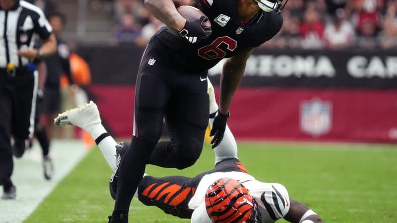 Arizona Cardinals running back James Conner (6) breaks past Cincinnati Bengals safety Nick Scott (33) at State Farm Stadium in Glendale on Oct. 8, 2023.