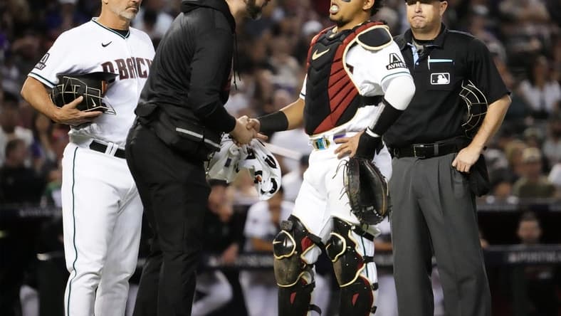 Oct 11, 2023; Phoenix, AZ, USA; Arizona Diamondbacks catcher Gabriel Moreno (14) reacts to an injury against the Los Angeles Dodgers in the fifth inning during Game 3 of the NLDS at Chase Field. Mandatory Credit: Rob Schumacher-Arizona Republic