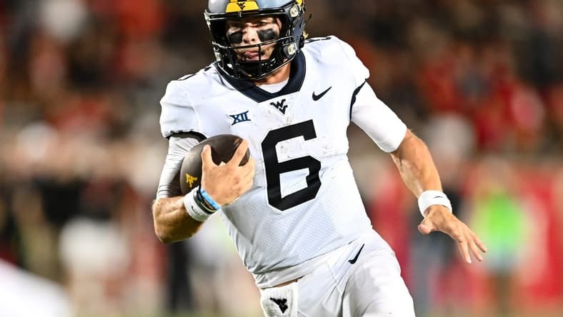 Oct 12, 2023; Houston, Texas, USA; West Virginia Mountaineers quarterback Garrett Greene (6) runs the ball in for a touchdown during the fourth quarter against the Houston Cougars  at TDECU Stadium. Mandatory Credit: Maria Lysaker-USA TODAY Sports