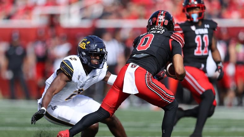 Oct 14, 2023; Salt Lake City, Utah, USA; California Golden Bears defensive back Craig Woodson (2) tackles Utah Utes wide receiver Mikey Matthews (0) in the second quarter at Rice-Eccles Stadium. Mandatory Credit: Rob Gray-USA TODAY Sports