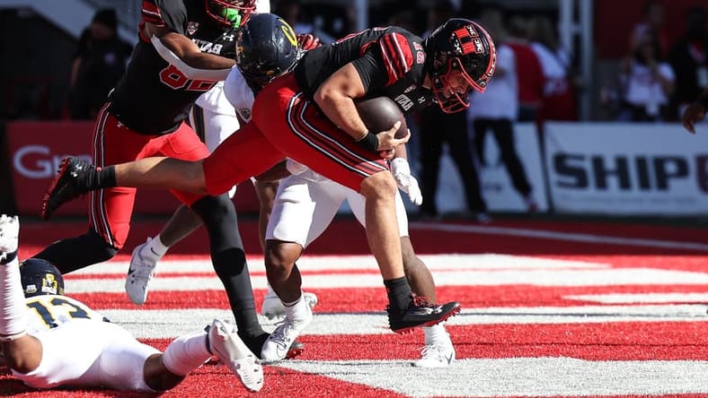 Oct 14, 2023; Salt Lake City, Utah, USA; Utah Utes quarterback Bryson Barnes (16) runs in for a touchdown against the California Golden Bears in the second half at Rice-Eccles Stadium. Mandatory Credit: Rob Gray-USA TODAY Sports