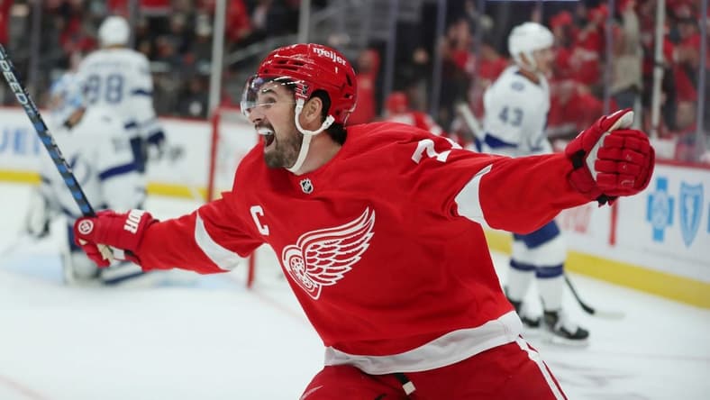 Oct 14, 2023; Detroit, Michigan, USA; Detroit Red Wings center Dylan Larkin celebrates a goal by right wing Alex DeBrincat against Tampa Bay Lightning goaltender Jonas Johansson during first-period action on Saturday, Oct. 14, 2023, in Detroit, Michigan. Mandatory Credit: Kirthmon F. Dozier-USA TODAY Sports