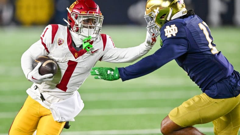 Oct 14, 2023; South Bend, Indiana, USA; USC Trojans wide receiver Zachariah Branch (1) carries as Notre Dame Fighting Irish safety Ramon Henderson (11) defends in the first quarter at Notre Dame Stadium. Mandatory Credit: Matt Cashore-USA TODAY Sports