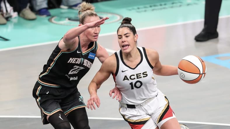 Oct 15, 2023; Brooklyn, New York, USA; Las Vegas Aces guard Kelsey Plum (10) drives around New York Liberty guard Courtney Vandersloot (22) in the first quarter during game three of the 2023 WNBA Finals at Barclays Center. Mandatory Credit: Wendell Cruz-USA TODAY Sports