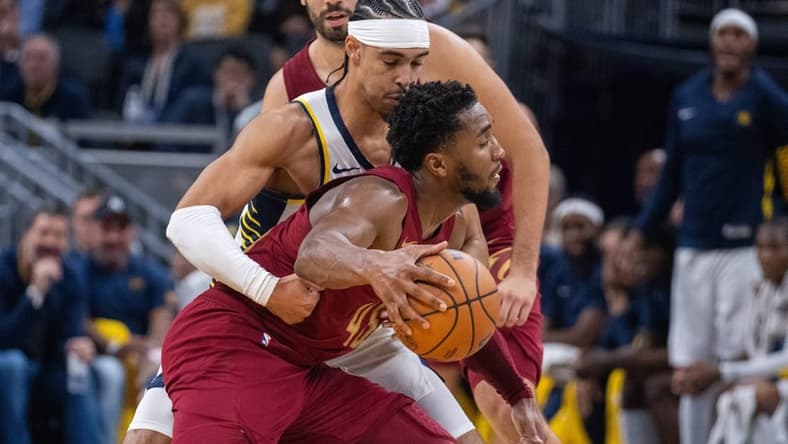 Oct 20, 2023; Indianapolis, Indiana, USA; Cleveland Cavaliers guard Donovan Mitchell (45) dribbles the ball while Indiana Pacers guard Andrew Nembhard (2) defends in the second half at Gainbridge Fieldhouse. Mandatory Credit: Trevor Ruszkowski-USA TODAY Sports
