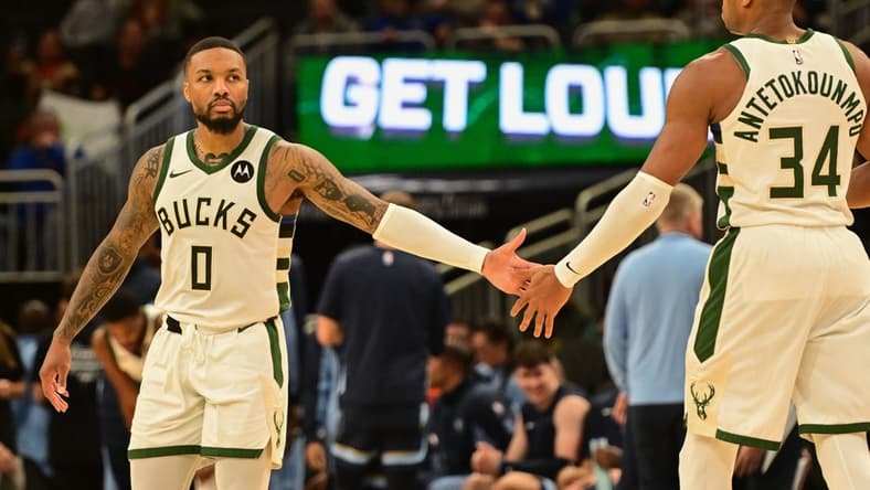 Oct 20, 2023; Milwaukee, Wisconsin, USA; Milwaukee Bucks guard Damian Lillard (0) greets forward Giannis Antetokounmpo (34) during game against the Memphis Grizzlies at Fiserv Forum. Mandatory Credit: Benny Sieu-USA TODAY Sports