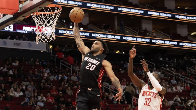 Oct 20, 2023; Houston, Texas, USA; Miami Heat forward Justin Champagnie (20) dunks as Houston Rockets forward Jeff Green (32) defends in the fourth quarter at Toyota Center. Mandatory Credit: Thomas Shea-USA TODAY Sports