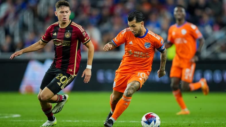 Oct 21, 2023; Cincinnati, Ohio, USA; FC Cincinnati midfielder Luciano Acosta (10) dribbles the ball against Atlanta United FC midfielder Matheus Rossetto (20) in the second half at TQL Stadium. Mandatory Credit: Aaron Doster-USA TODAY Sports